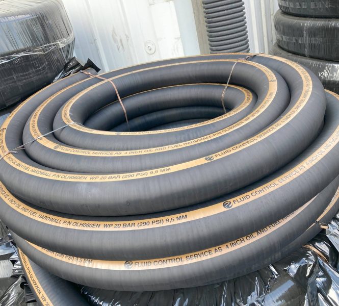 Coiled black industrial rubber hoses