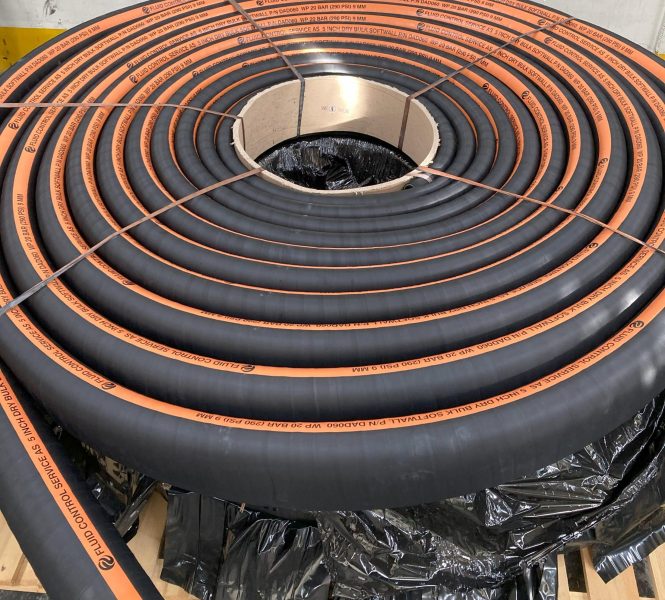 Coiled black industrial hose rolls
